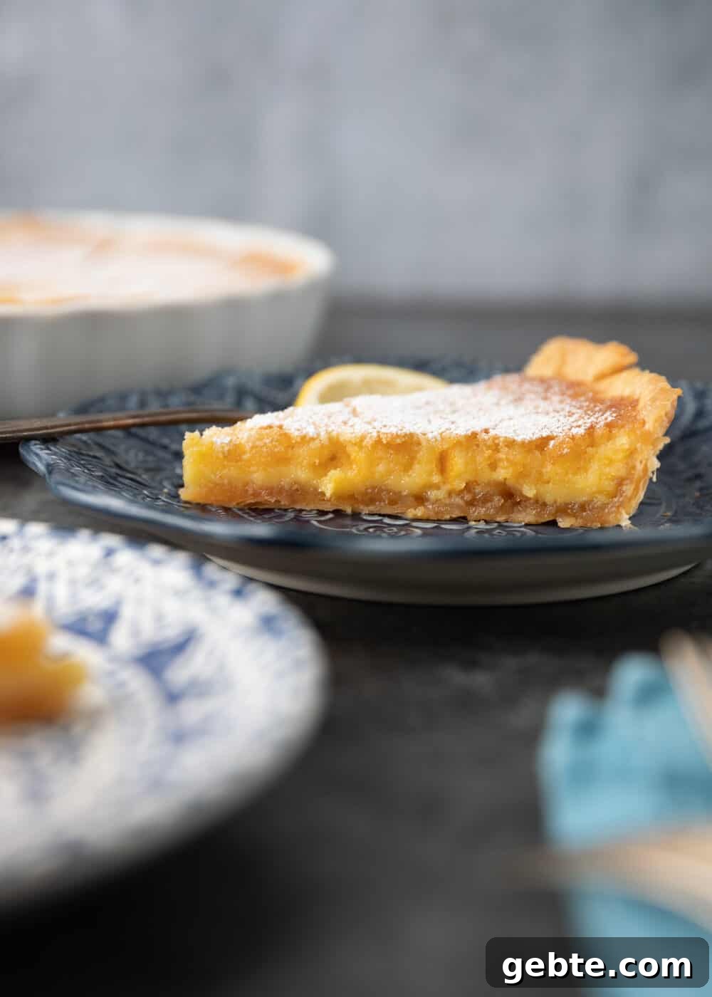 THE easiest lemon tart around. Lazy Mary's Lemon Tart uses an entire Meyer lemon and all the ingredients, besides the tart shell, get mixed in a blender. Smooth, fragrant and delicious! side view: plates of lazy mary's lemon tart on table