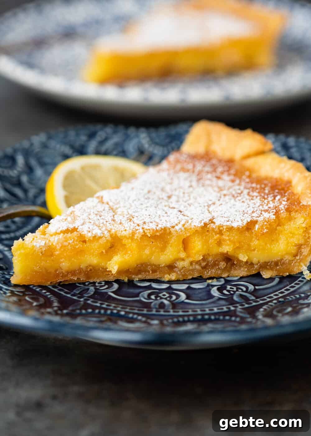 Lazy Mary's Meyer Lemon Tart Recipe 4 closeup side view: meyer lemon tart slice on blue plate
