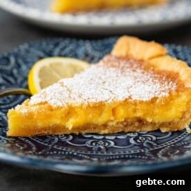 slice of meyer lemon tart on blue plate