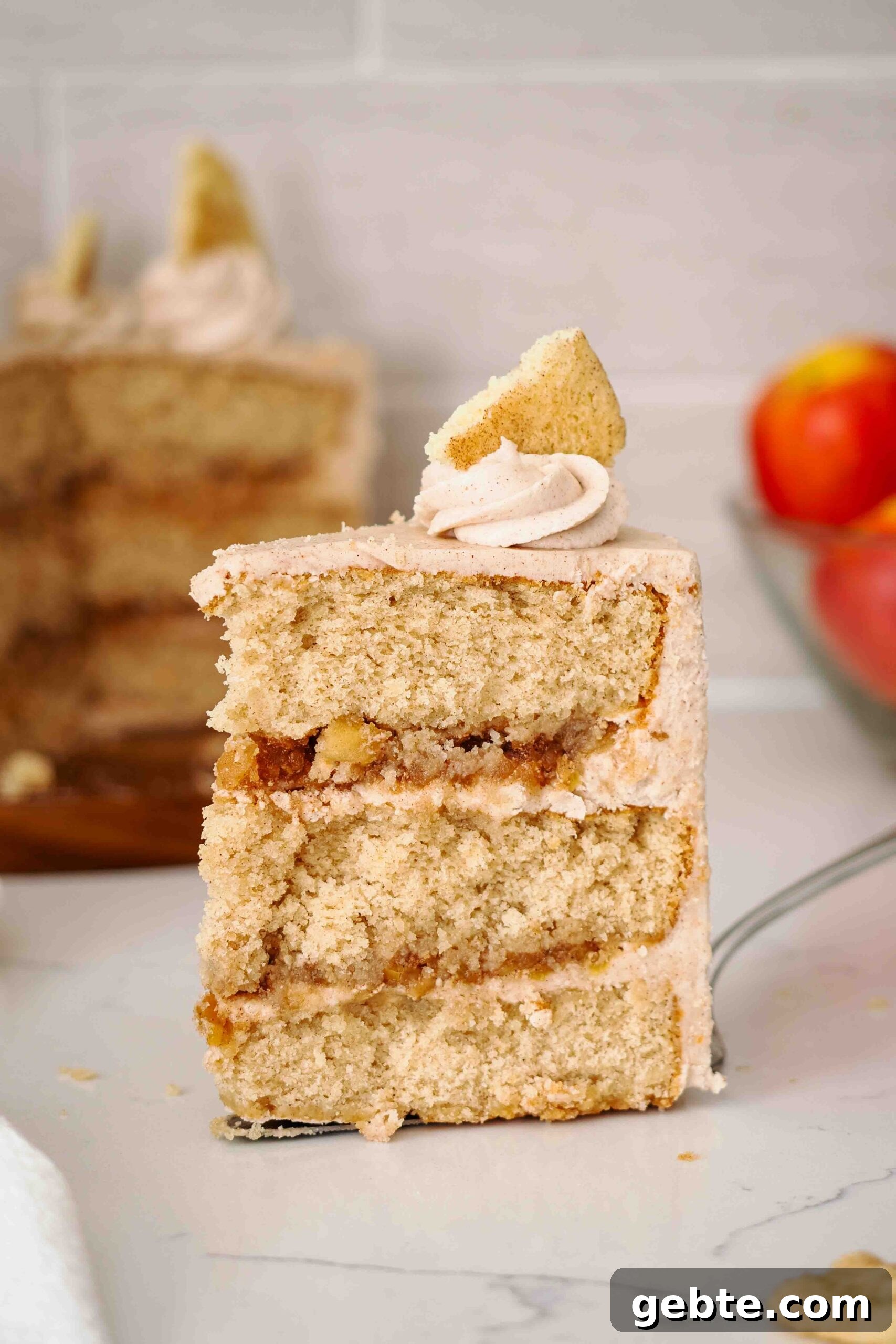 A large slice of apple snickerdoodle cake on a cake server.