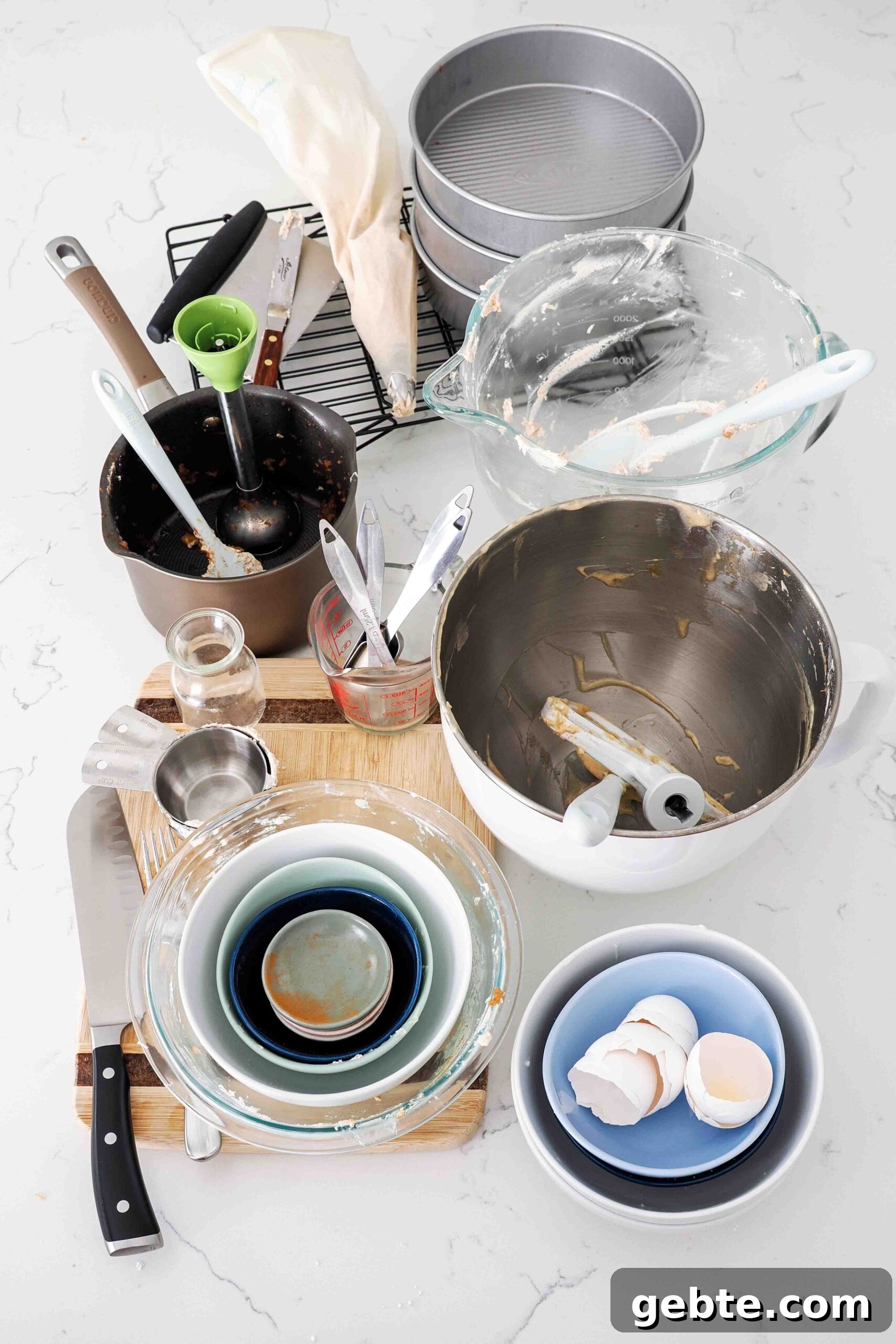 A huge pile of dishes used in making apple snickerdoodle layer cake.