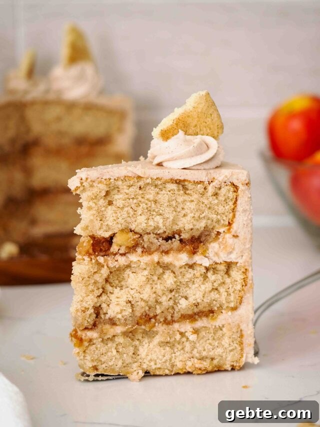 A large slice of apple snickerdoodle cake on a cake server.