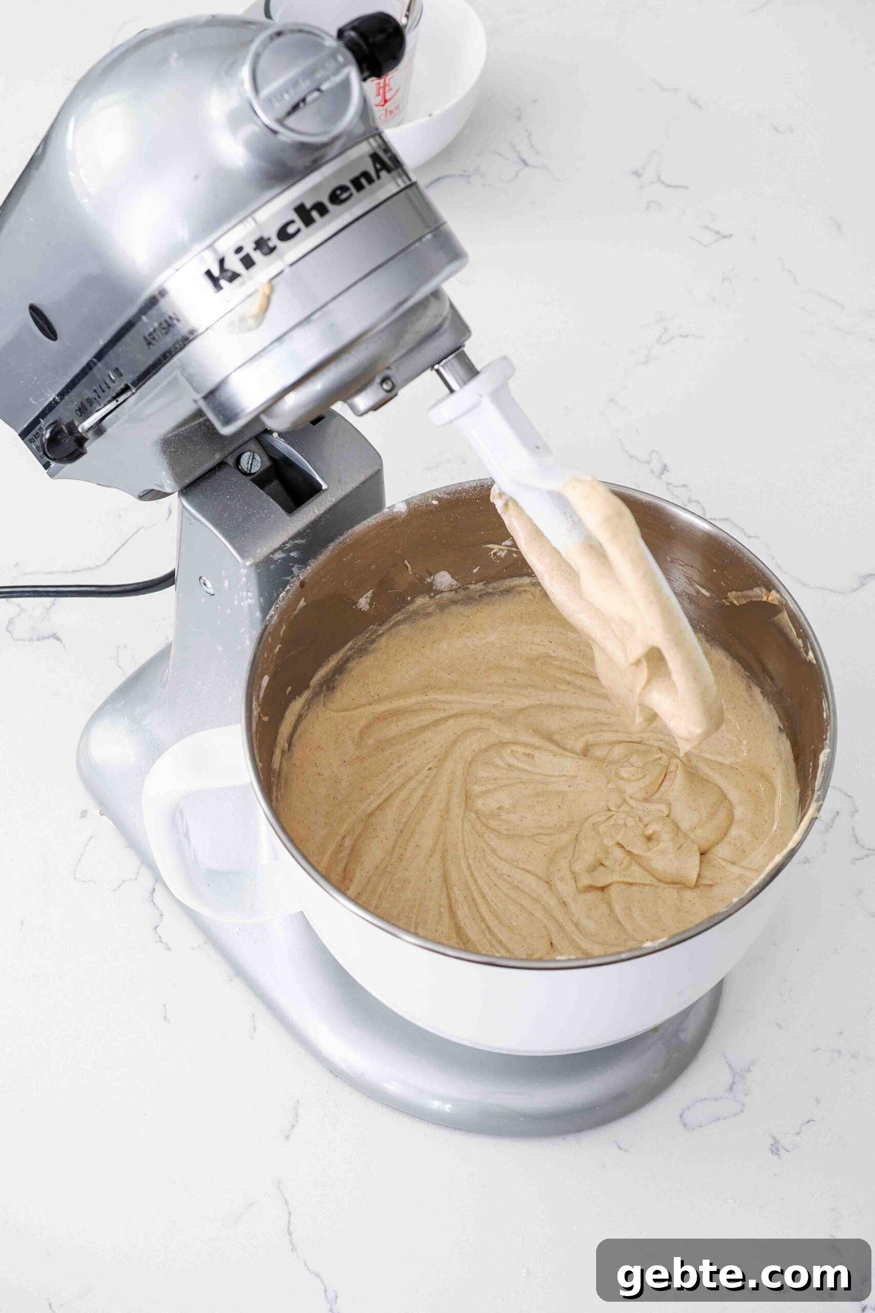 Cinnamon cake batter in a stand mixer bowl.