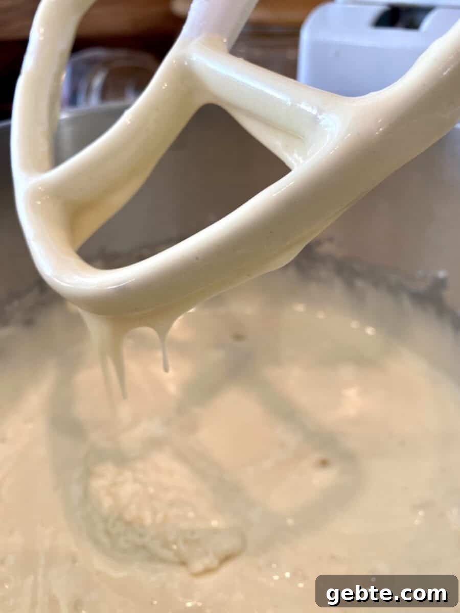Cake batter in a mixing bowl with a beater.
