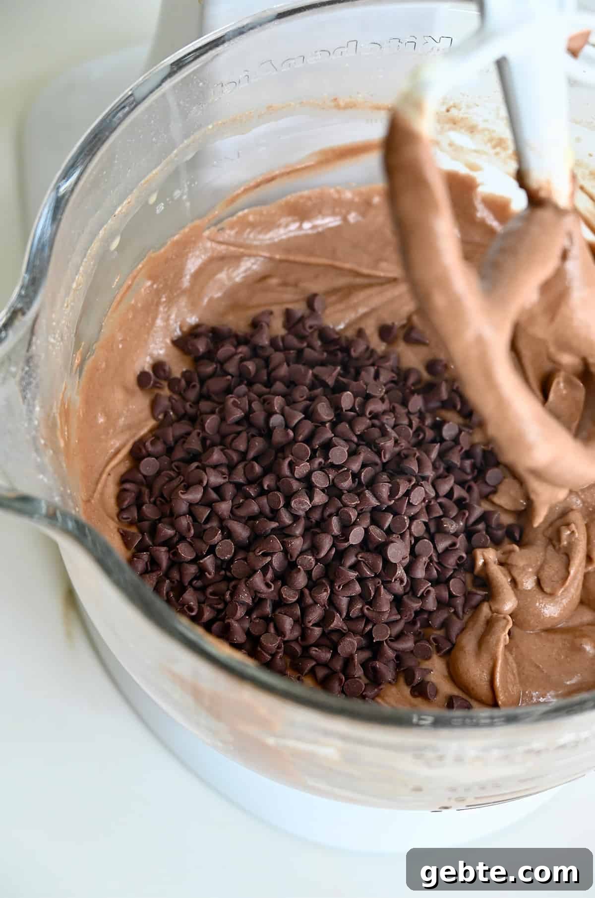 Homemade Polka Dot Cake Recipe 5 Mini chocolate chips and chocolate cake batter in a bowl of a stand mixer.