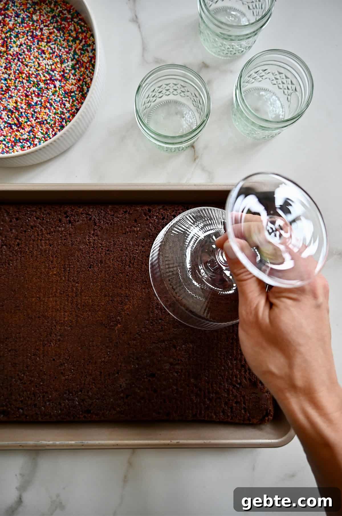 Homemade Polka Dot Cake Recipe 6 Cutting out cake on a jelly roll pan with a cocktail glass.