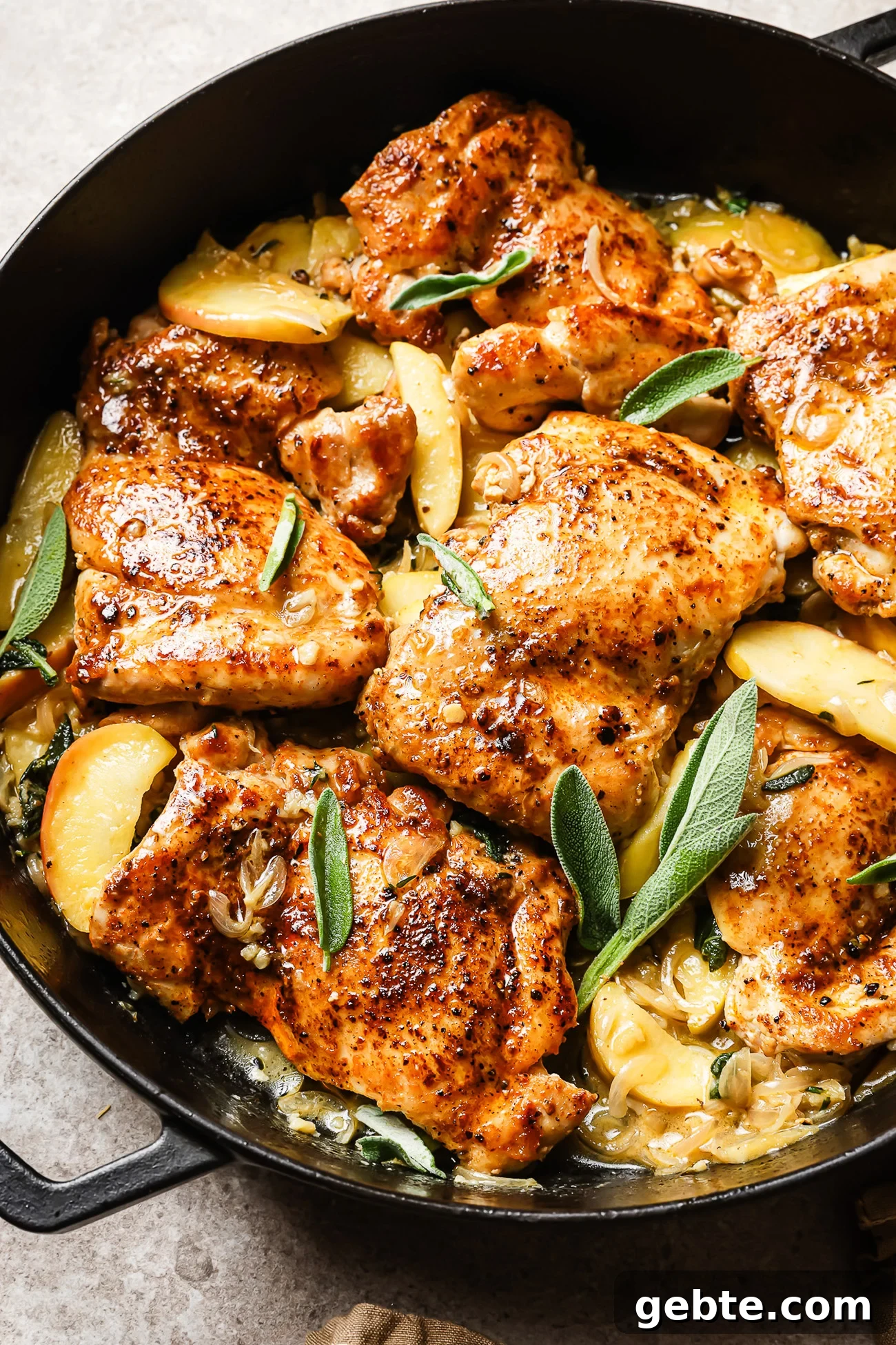 Apple cider chicken in a cast iron skillet.