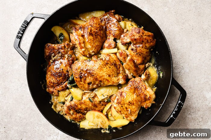 apple cider chicken in a cast iron skillet.