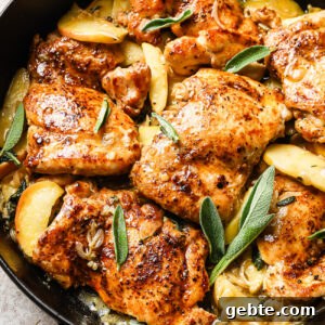Apple cider chicken in a cast iron skillet.