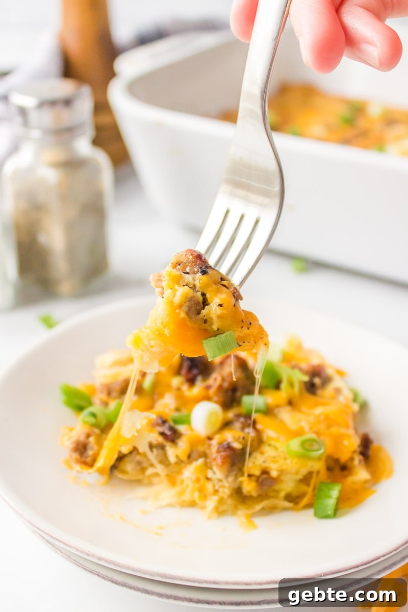 Enjoy a piece of Easy Brunch Casserole fork digging into piece of brunch casserole on plate