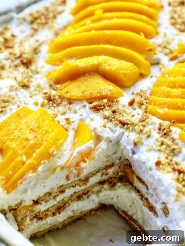 mango float dessert with a slice taken out so you can see the layers inside.