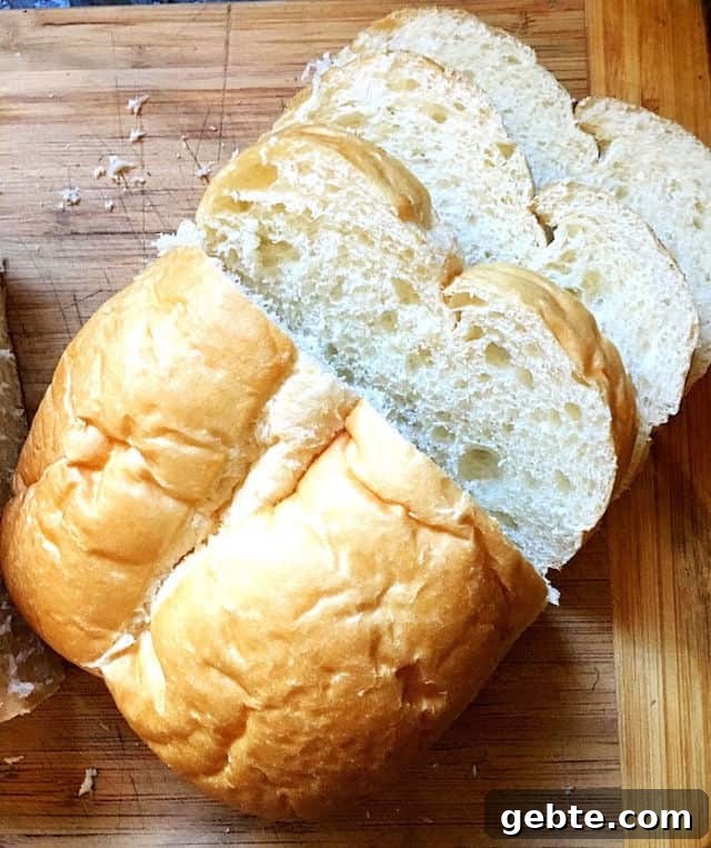 homemade loaf of bread on cutting board with slices