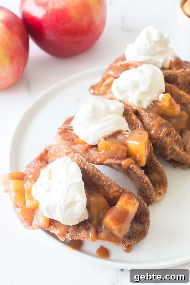 apple pie tacos on white plate with caramel sauce and cool whip