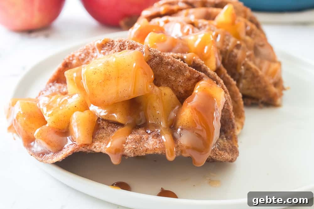 close up shot of apple pipe tacos with caramel sauce drizzled over apples
