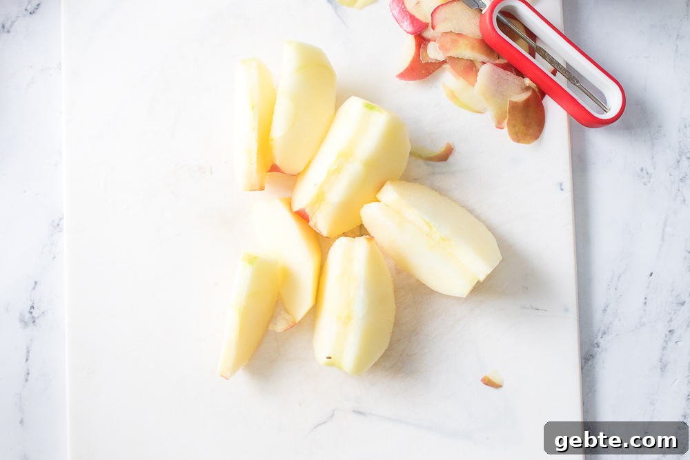 apple peeled and sliced on cutting board