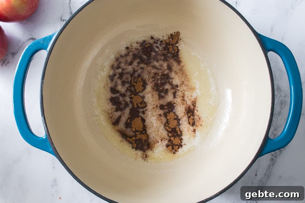 dutch oven with melted butter and apple pie spice