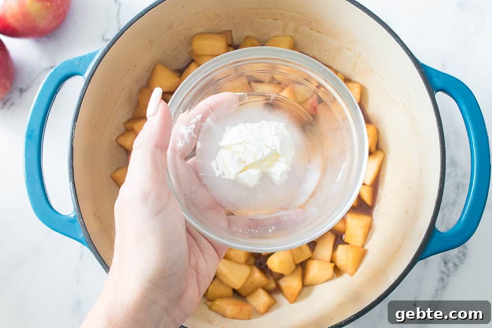 hand holding glass bowl with water and cornstarch