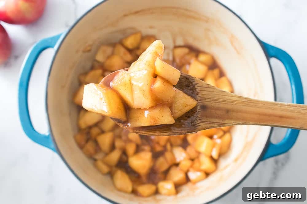 wooden spoon with scoop of apple pie filing