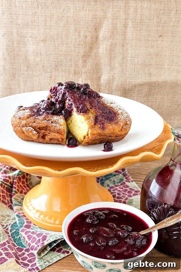 Crispy Deep Fried French Toast for Your Dream Brunch 2 Deep fried french toast with peach blueberry sauce served on a footed cake stand.