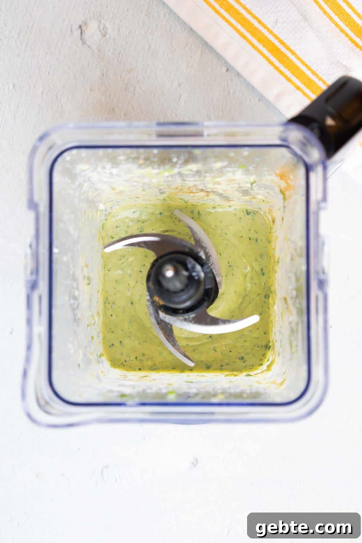 Avocado dressing blended until smooth in a blender.