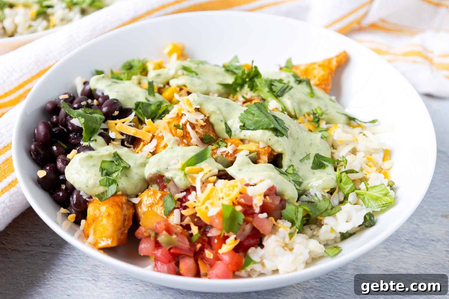 Southwest chicken rice bowls with pico de gallo, cilantro lime rice, black beans, corn, cheese, and avocado dressing