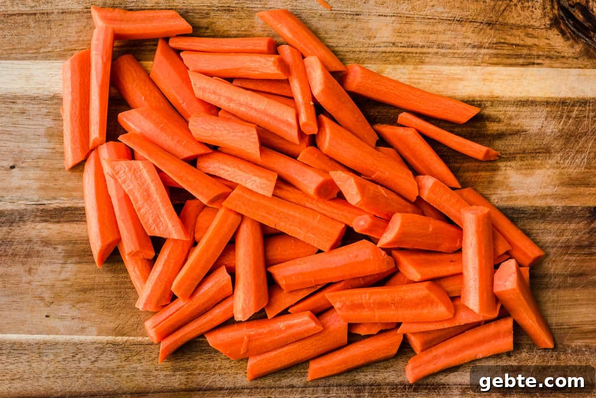 Oven-Roasted Carrots and Dates with Pistachio Pesto 4 Cut carrots on a wooden cutting board.