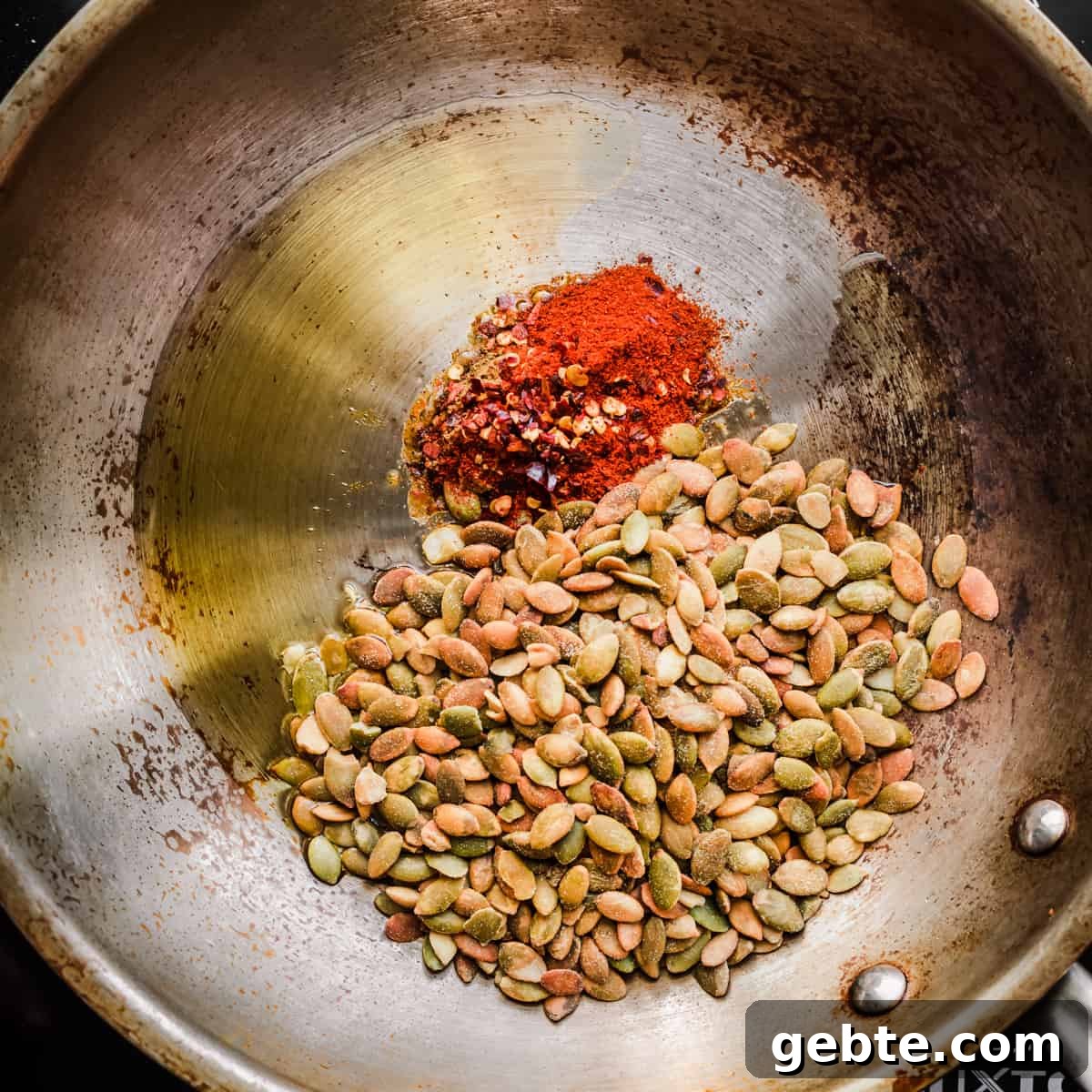 Oven-Roasted Carrots and Dates with Pistachio Pesto 10 Seed sprinkle ingredients in a frying pan before being cooked.