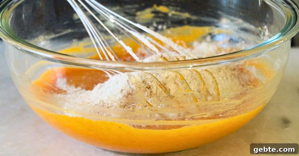 combining the wet and dry ingredients for pumpkin spice chiffon cake