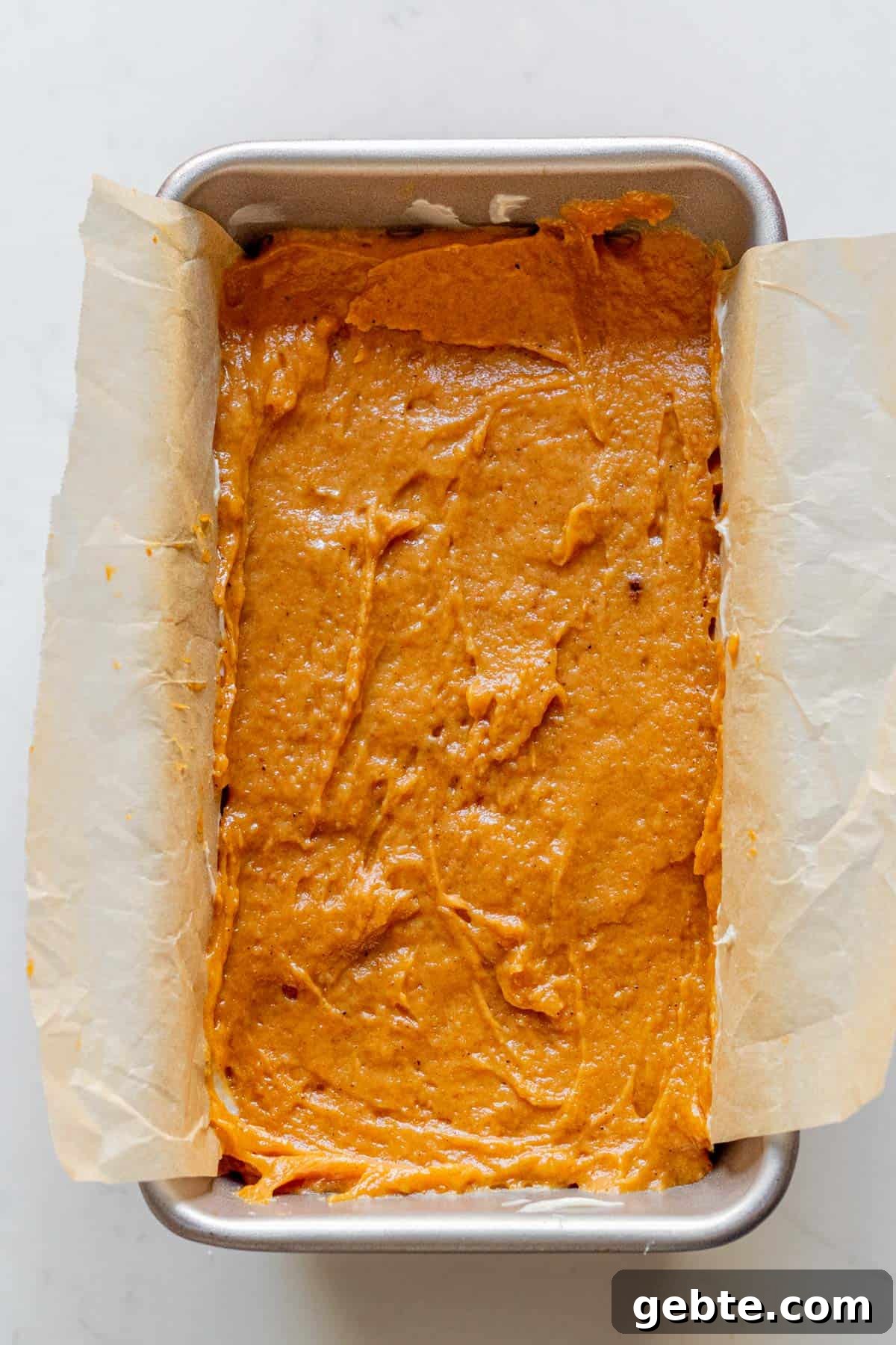 Pumpkin Cream Cheese Swirl Bread 4 pumpkin bread batter in a loaf pan