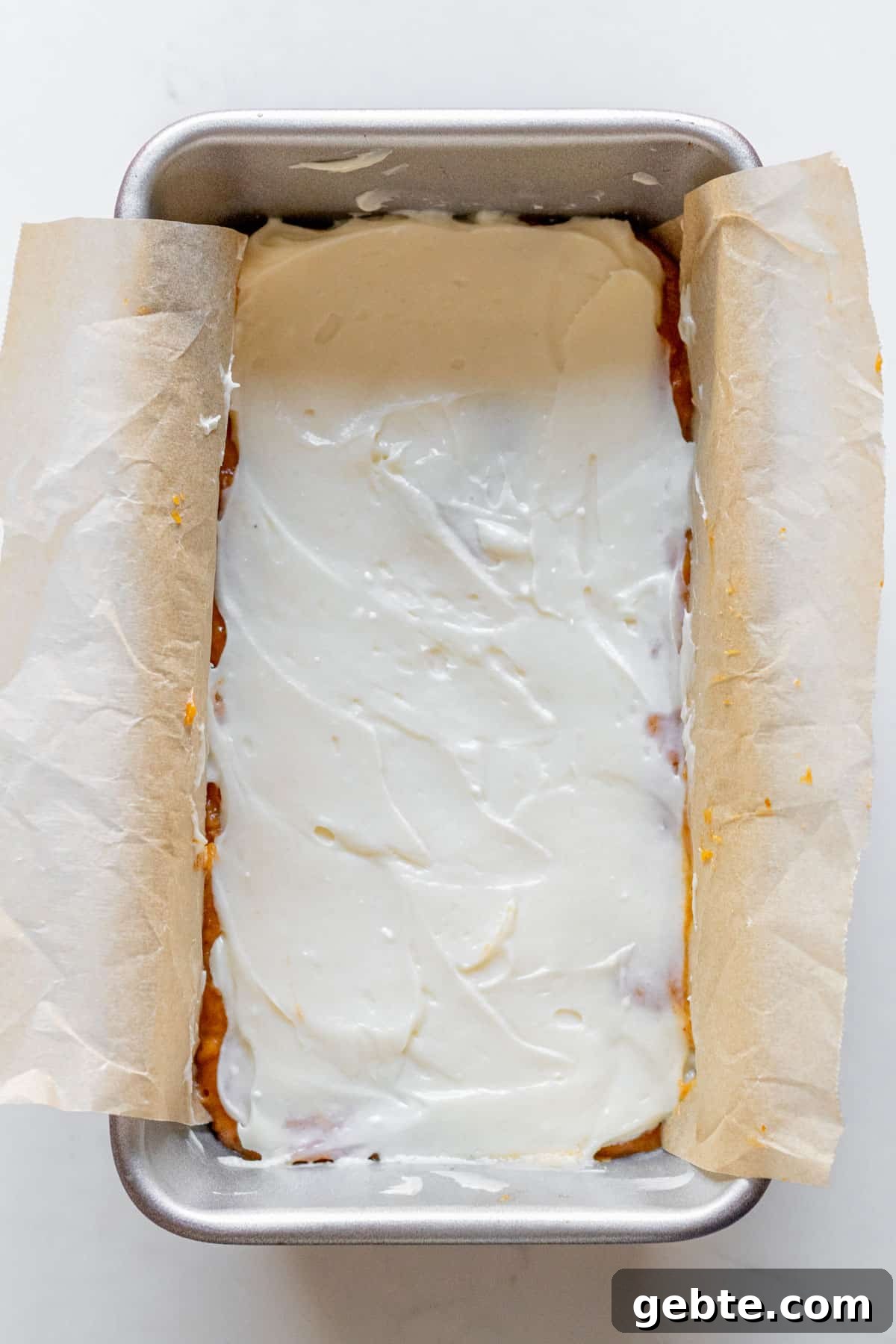 Pumpkin Cream Cheese Swirl Bread 6 cream cheese spread over pumpkin bread batter in a loaft pan
