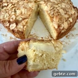 A baked one bowl pear & almond cake sliced