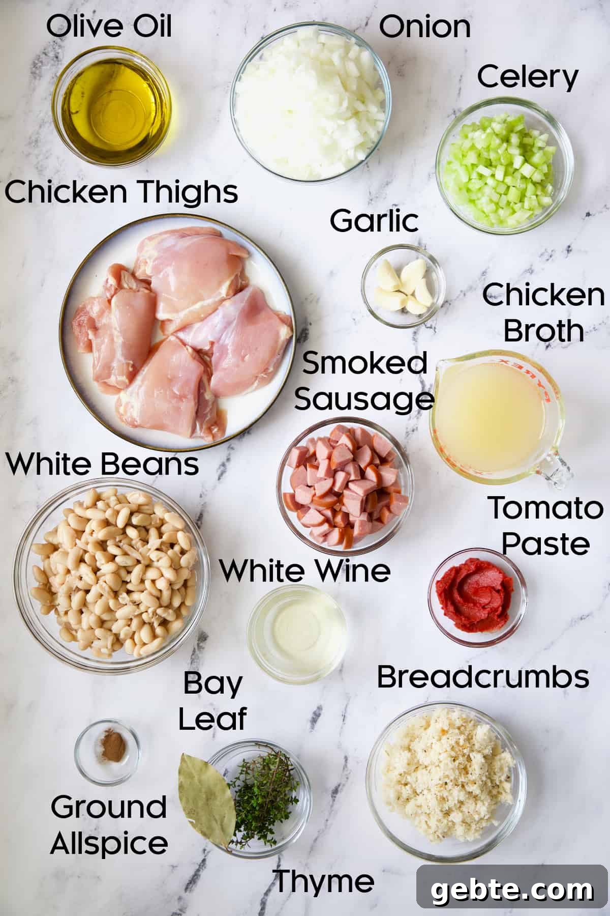 Photo of ingredients for Easy Weeknight Chicken and Sausage Cassoulet in glass bowls.