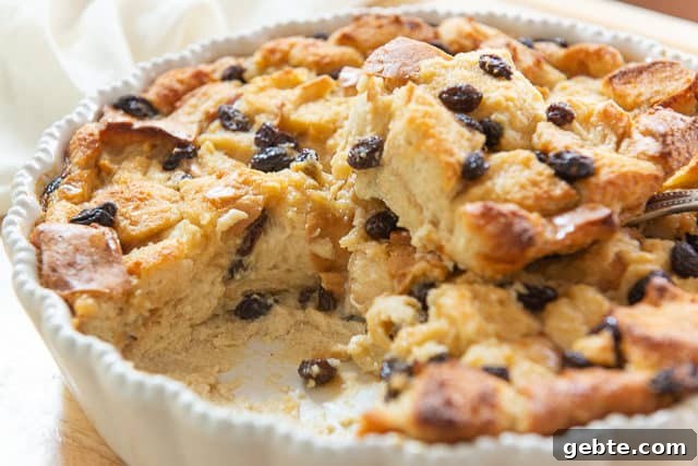 Bread Pudding Recipe - In a White Dish with Raisins and Showing Moist Interior
