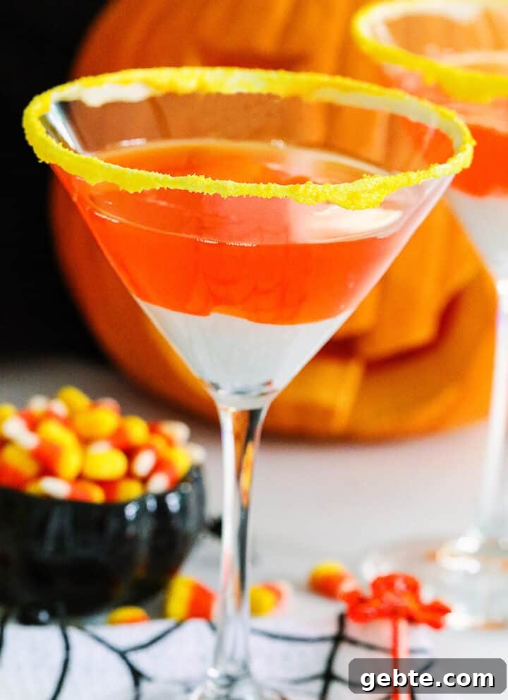 A Halloween party with candy corn martinis and a small black dish of candy corn nearby.