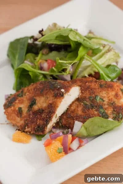 Pan-Seared Chicken Cutlets with Orange and Arugula 2 A plate of chicken cutlets with salad.