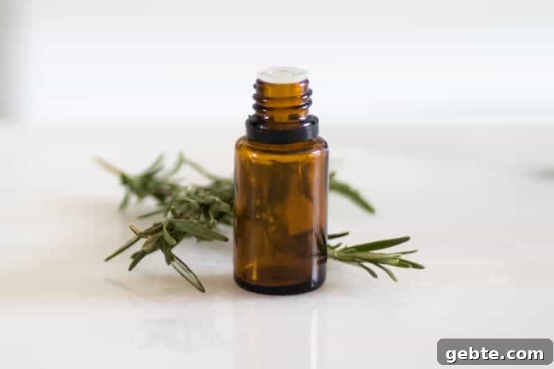 How to Use Rosemary Essential Oil: Blends and DIY Recipes 2 essential oil bottle and fresh rosemary on white marble