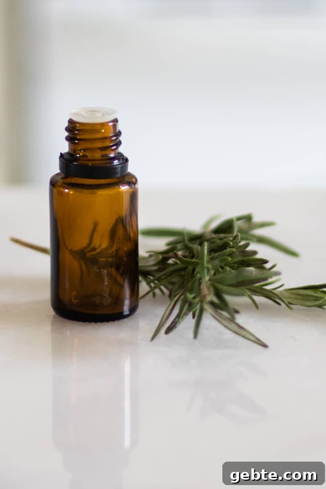 How to Use Rosemary Essential Oil: Blends and DIY Recipes 3 rosemary essential oil bottle and fresh rosemary leaves