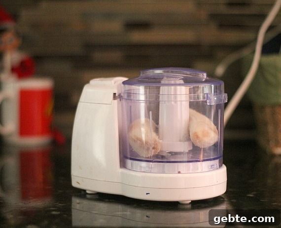 A fresh banana in a mini food processor