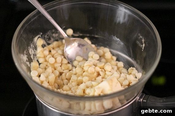 White chocolate chips and pureed banana in a double boiler bowl