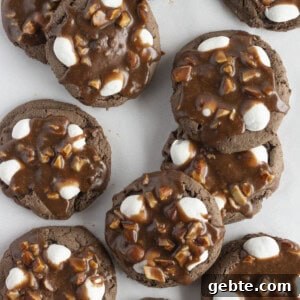 A dozen rocky road cookies on a white tray.