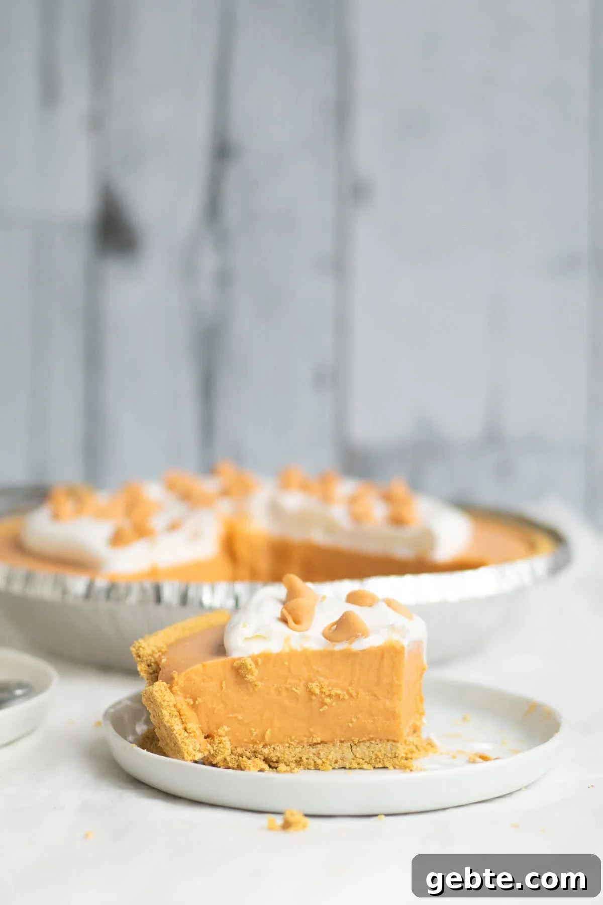 piece of butterscotch pudding pie on a white plate