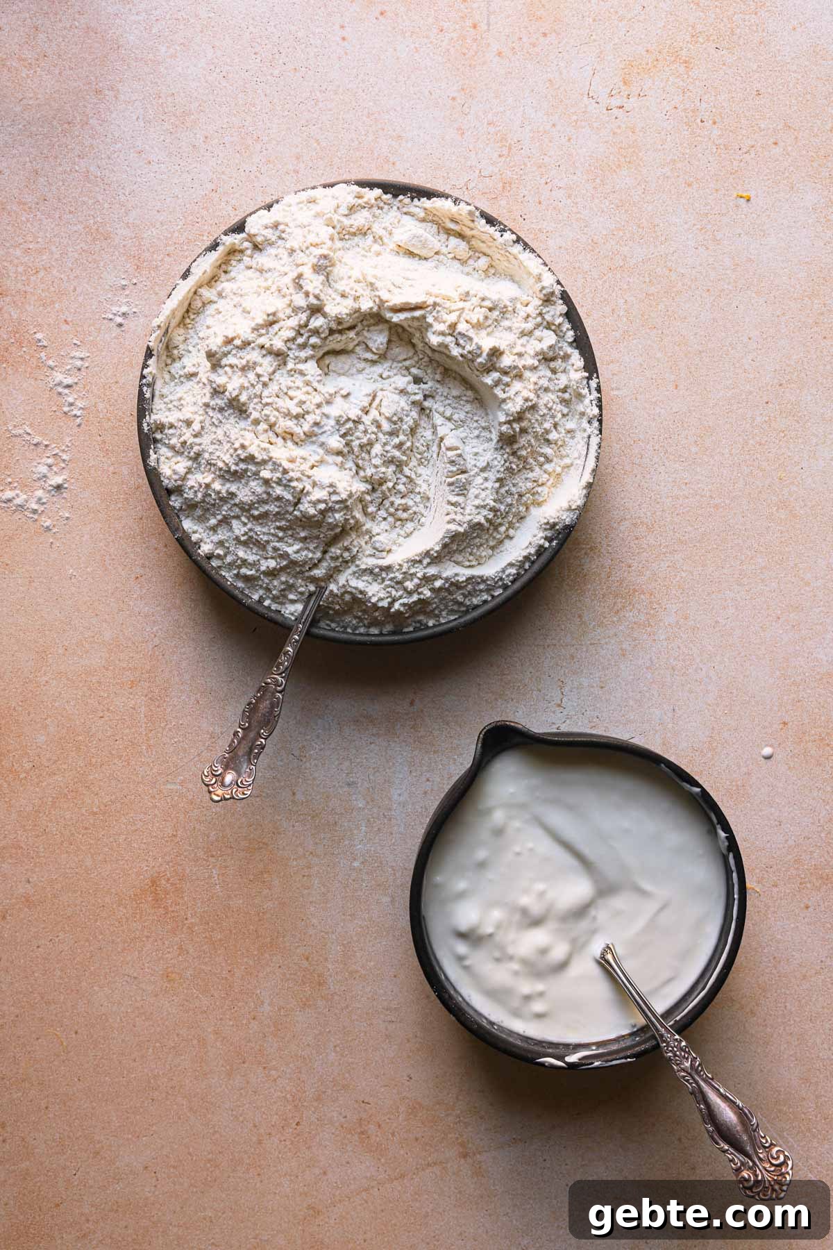 A bowl with flour mixture and a bowl with sour cream.