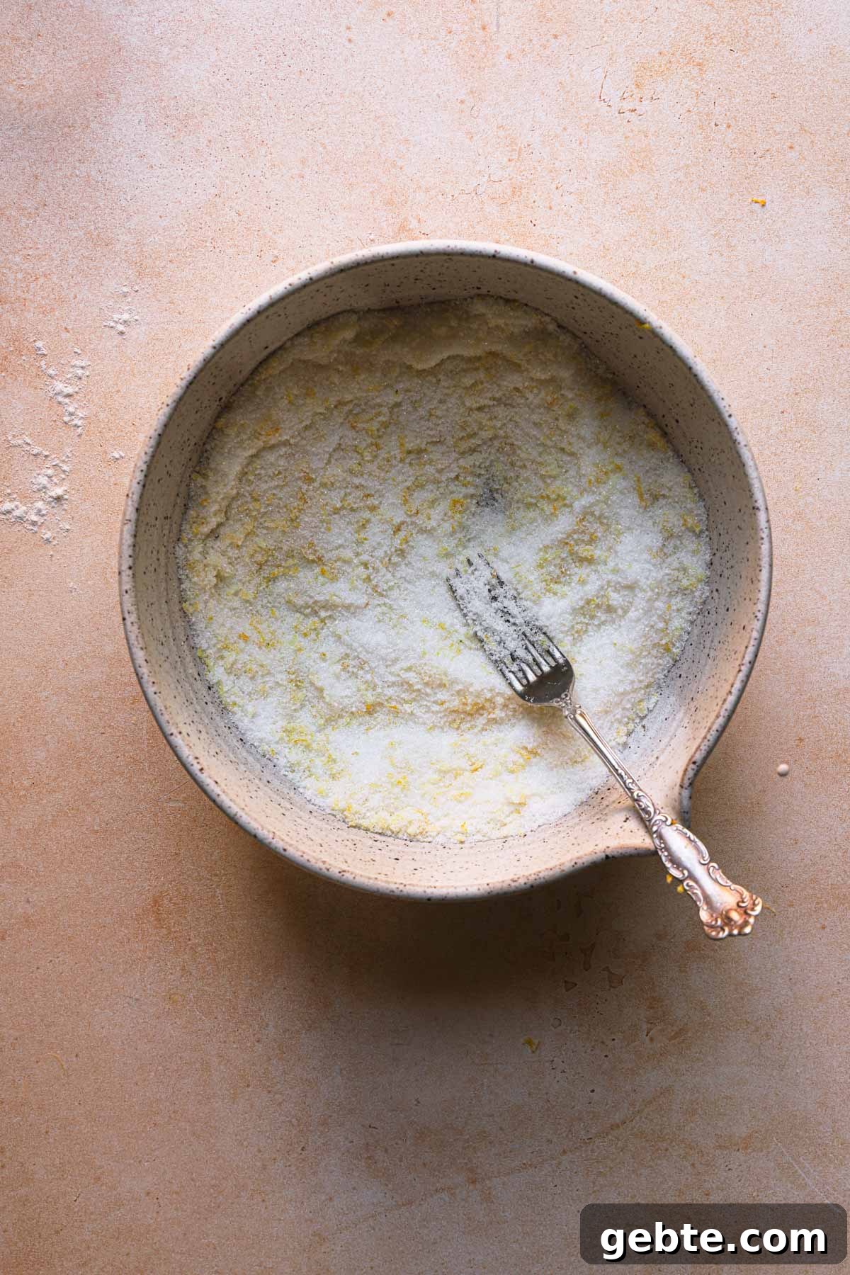A bowl with sugar and lemon zest.
