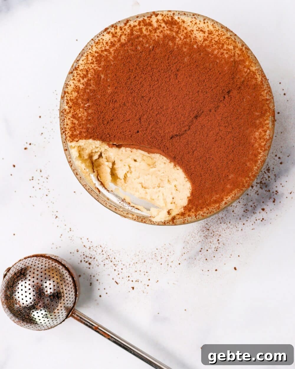 Keto Tiramisu Cottage Cheese Cookie Dough with one bite taken out with cocoa powder duster