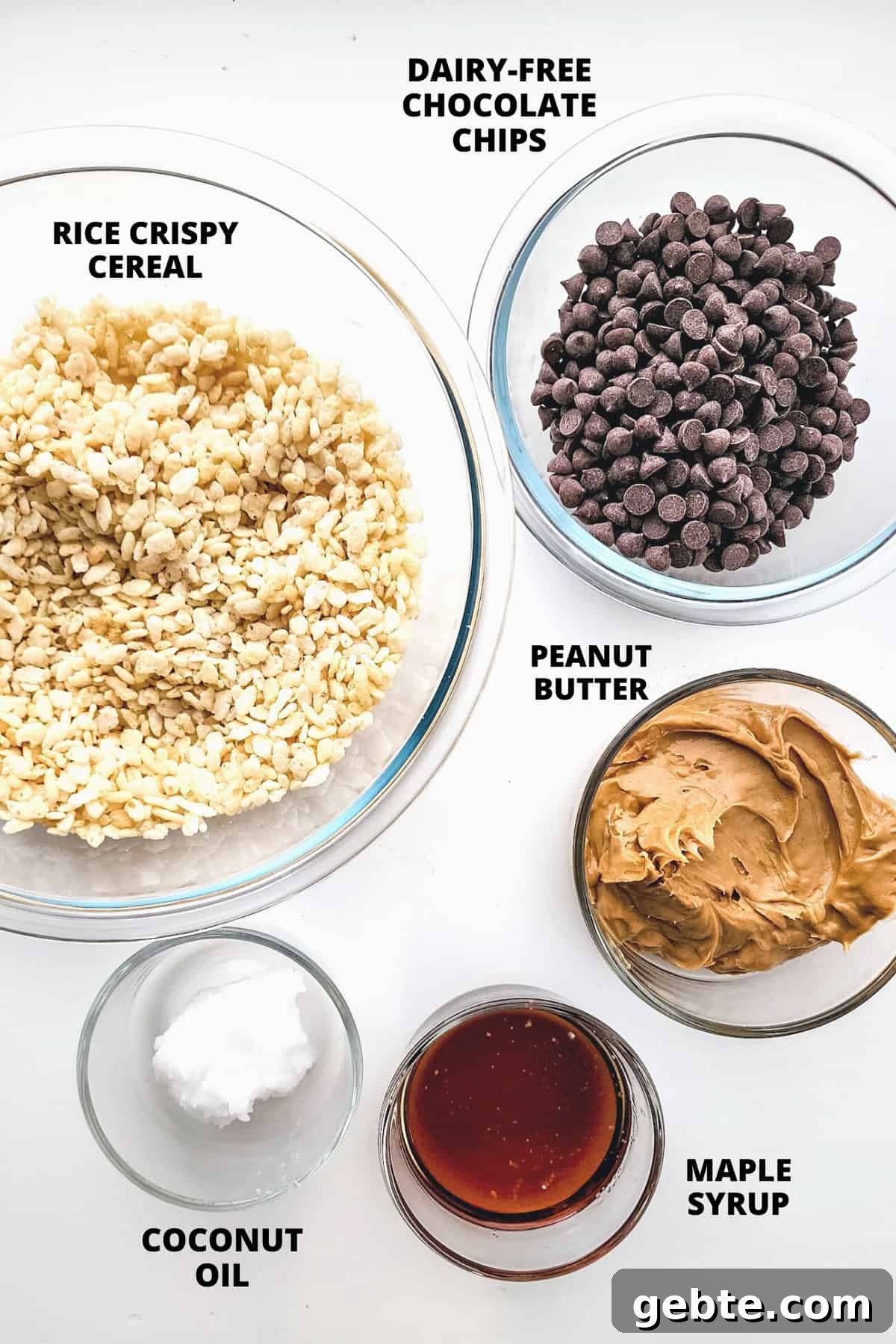 Ingredients for peanut butter crunchy bars laid out on white board.