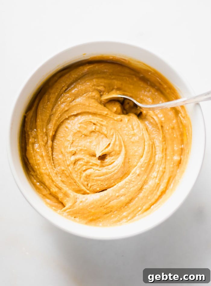 A creamy peanut butter mixture in a bowl with a spoon.