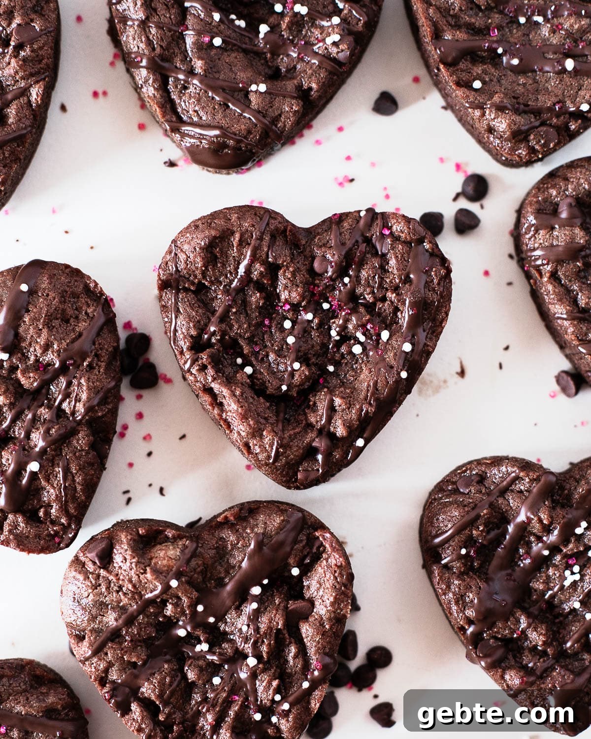overhead shot of heart shaped protein brownies on a white surface