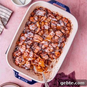 cinnamon roll with apple pie drizzled with creamy glaze.