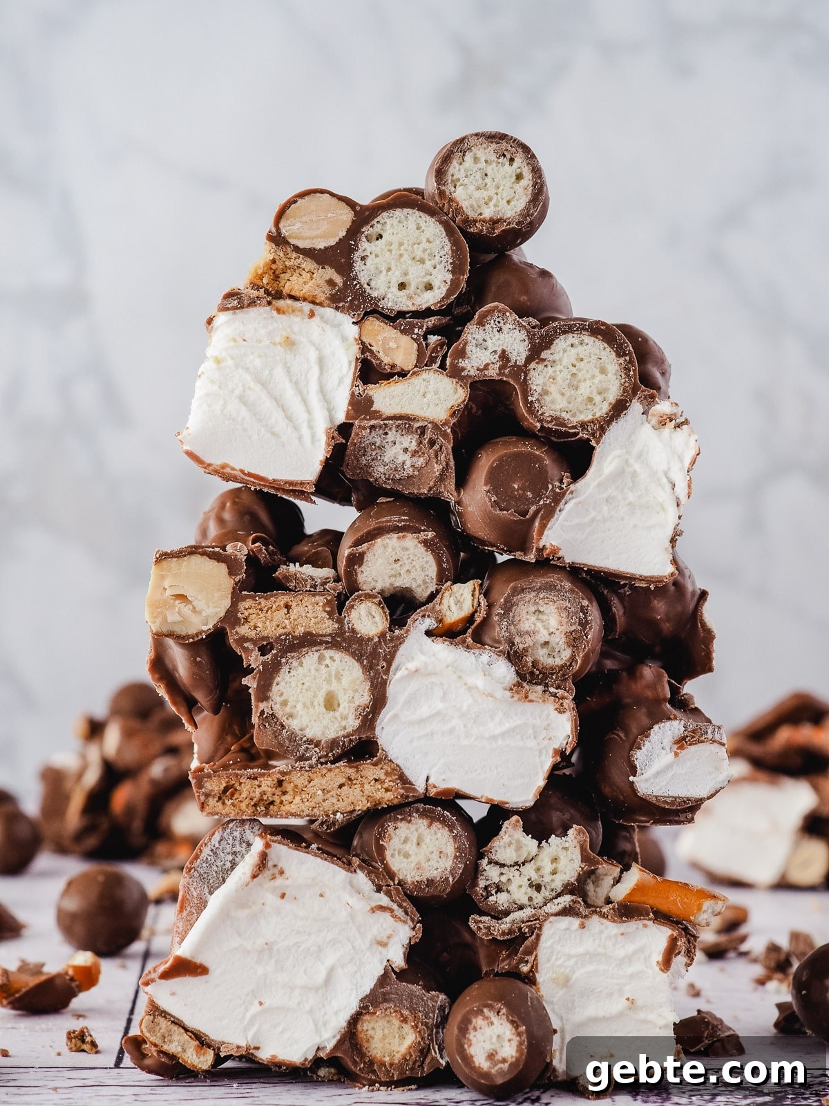 Stack of rocky road with Malteser balls in the background.